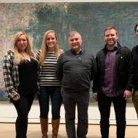 NYC alumni in front of Monet art work